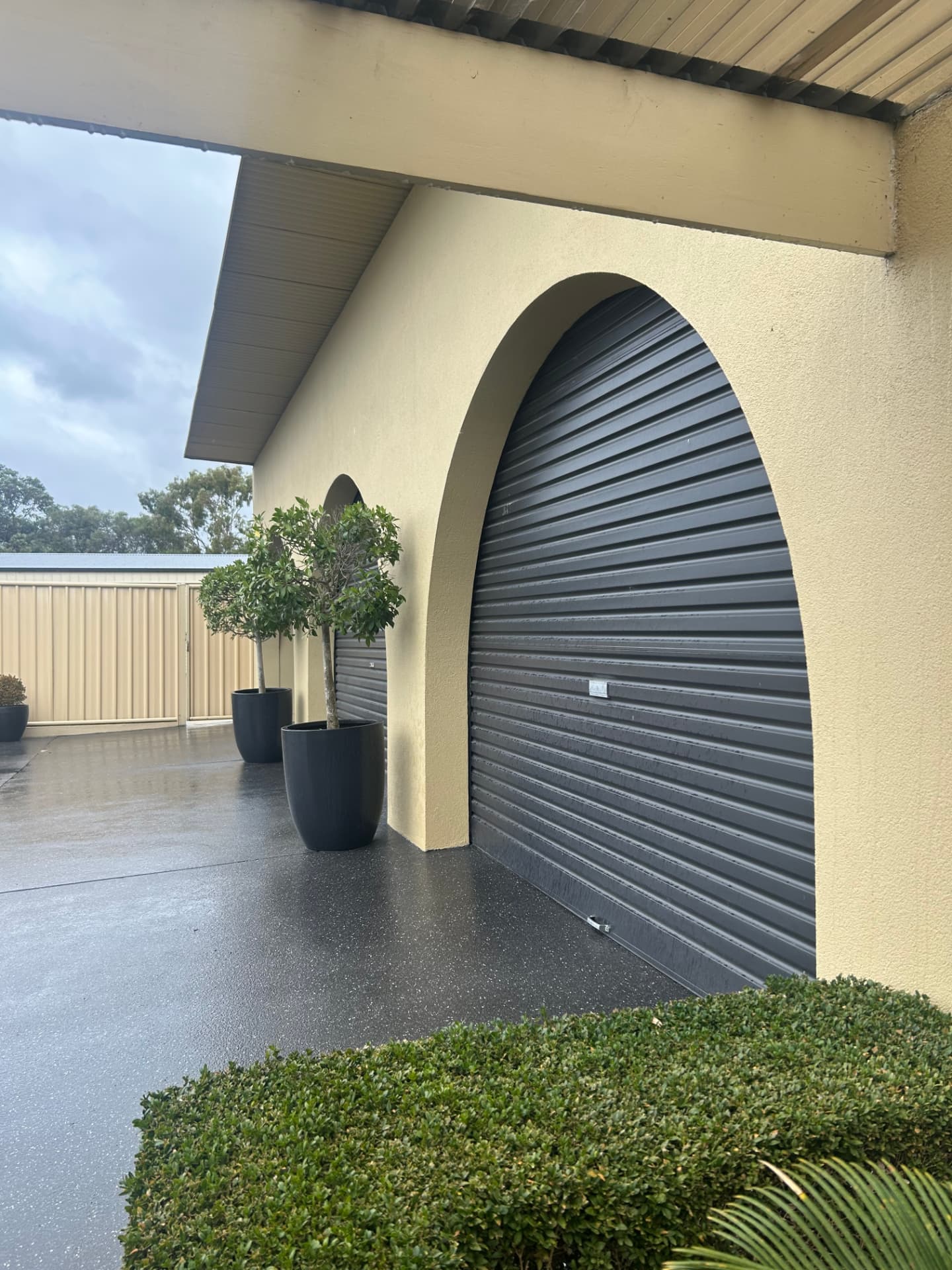 Arched rendered garage entry with textured finish