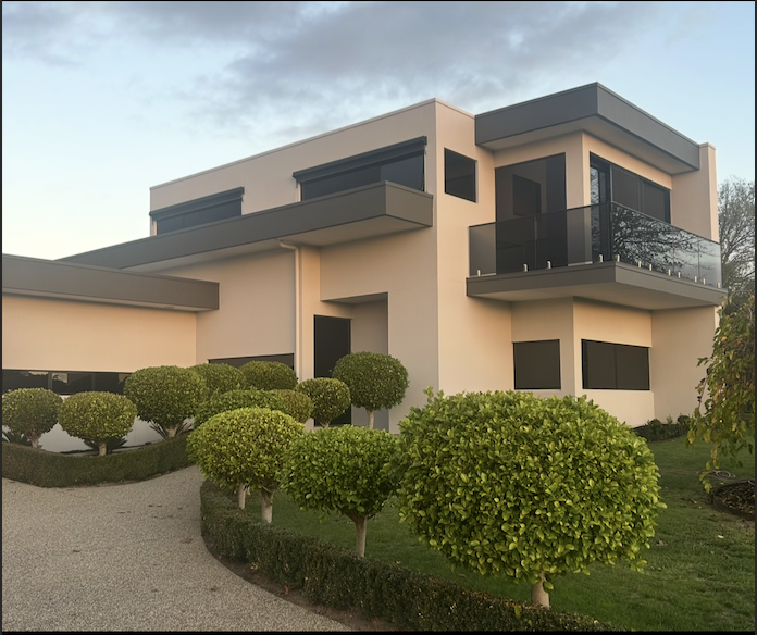 Modern two storey rendered home with manicured garden